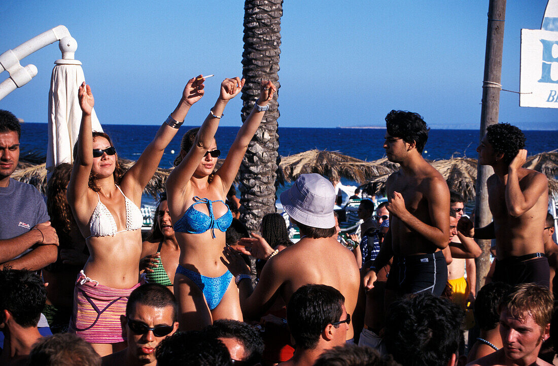 Group of young people partying at the Bora-Bora Disco Beach, Platja d´en Bossa, Ibiza, Balearic Islands, Spain