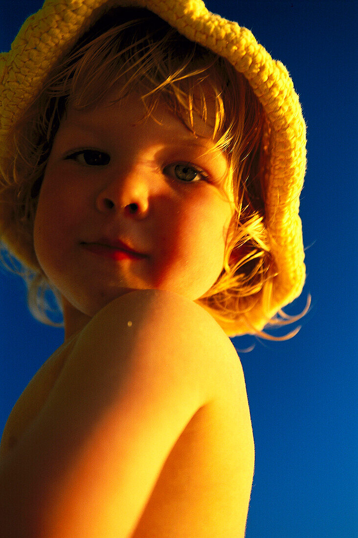 Small child, girl on the beach, wearing a sunhat, Anse Kerlan, Praslin, Seychelles, Indian Ocean