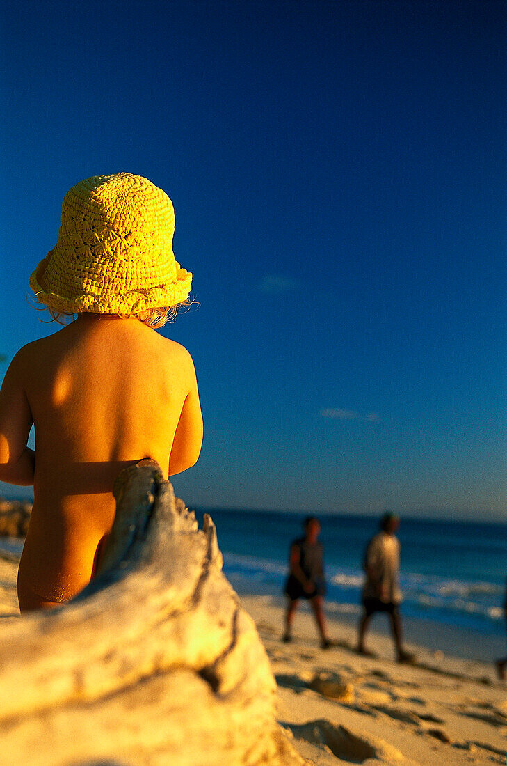 Small girl playing on the beach at sunset, Anse Kerlan, Praslin, Seychelles, Indian Ocean