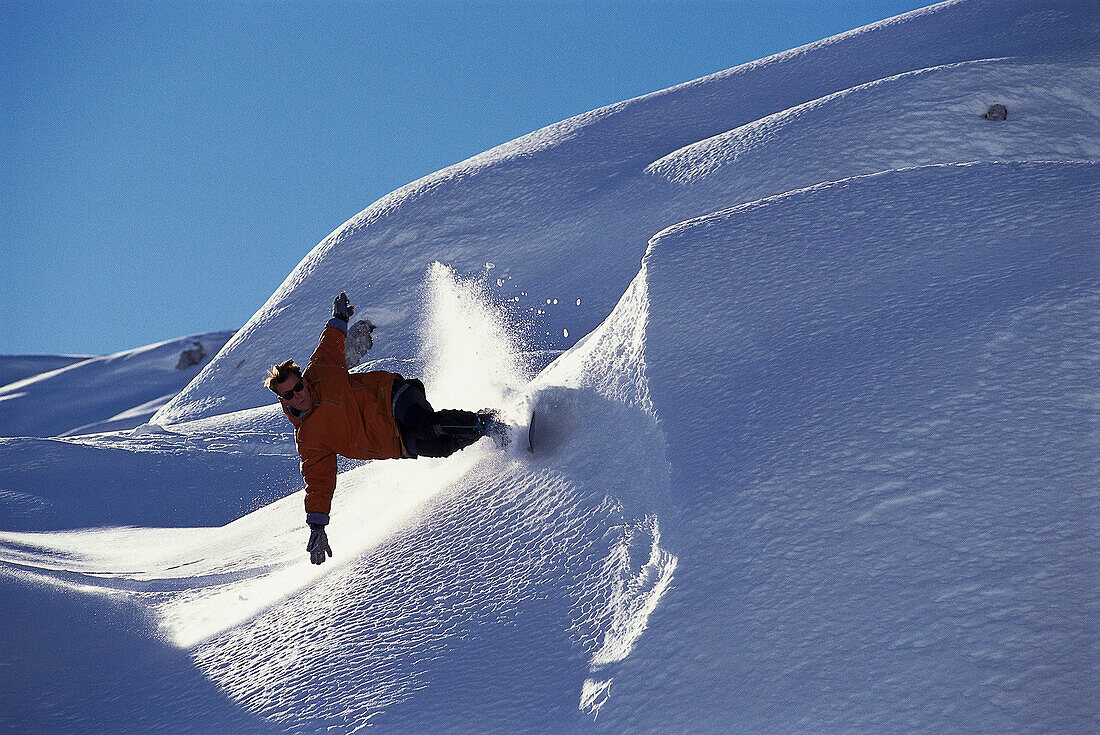 Snowboarder on slope, Davos, Graubunden, Switzerland