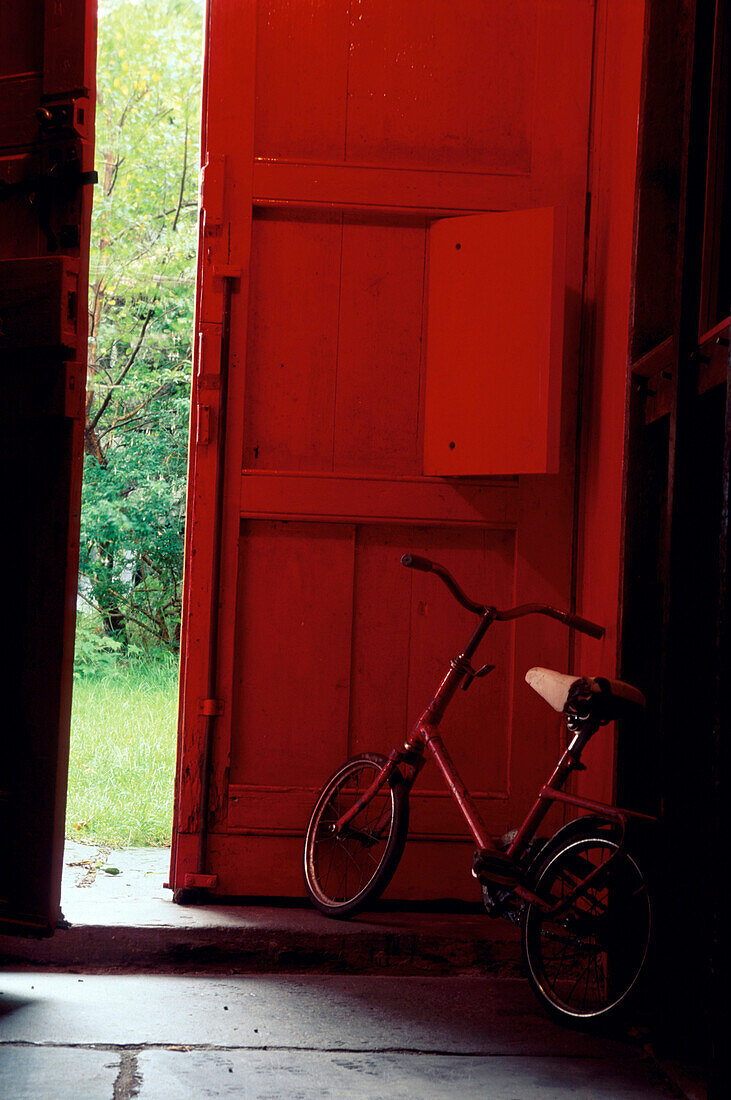 Childrens bike, bicycle stood in the hallway, North Wales, Wales, Great Britain