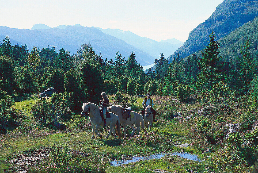 A couple horse riding, Fjell am Nordfjord, Norway