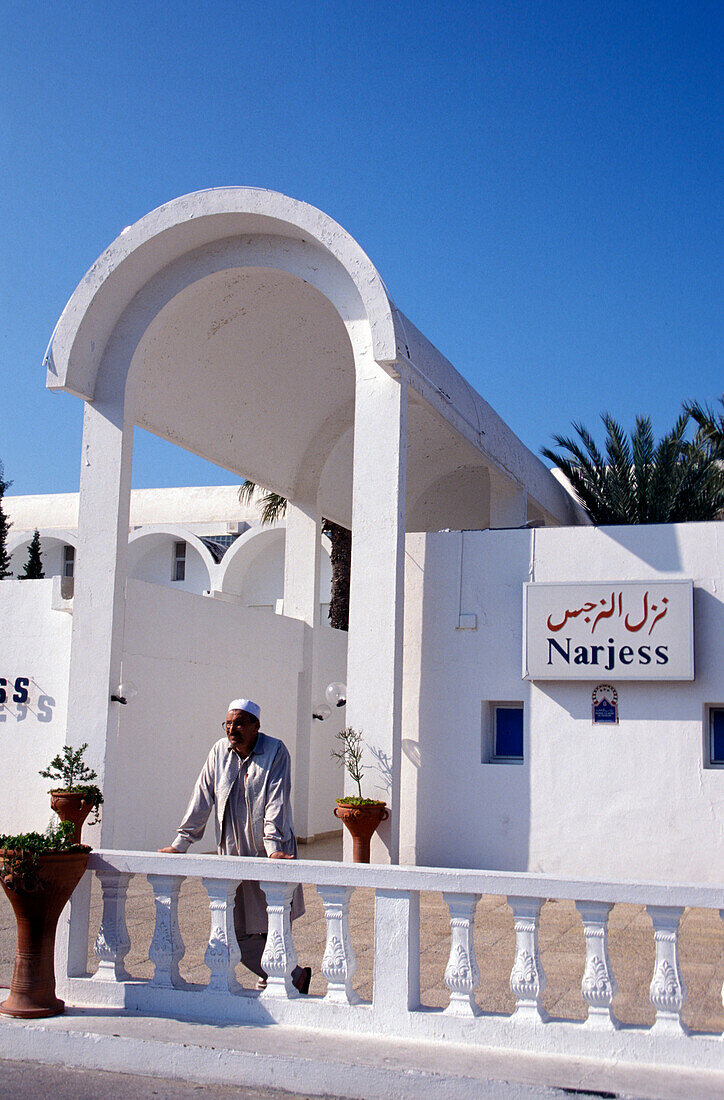 Person in front of the Dar Djerba hotel, Djerba, Tunesia, Africa