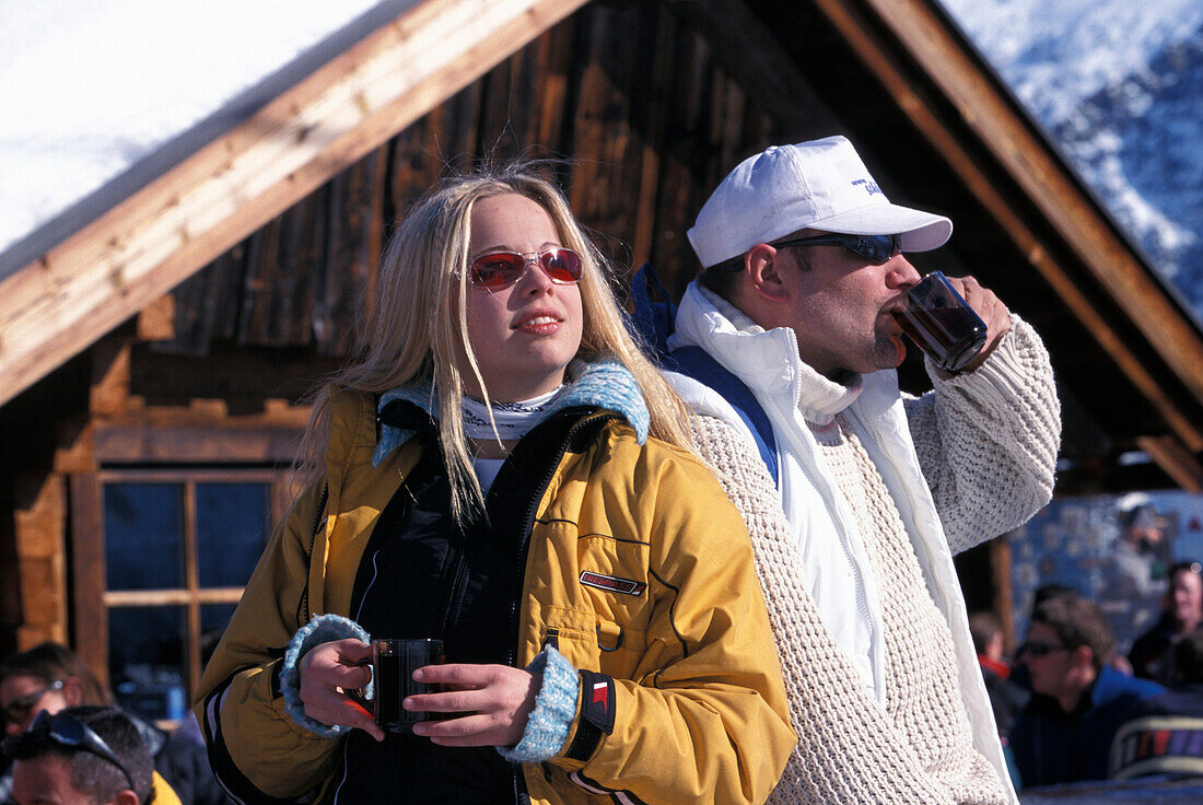 Couple having a warm drink at the Obstlerhuette, Soelden, Oetztal, Tyrol, Austria