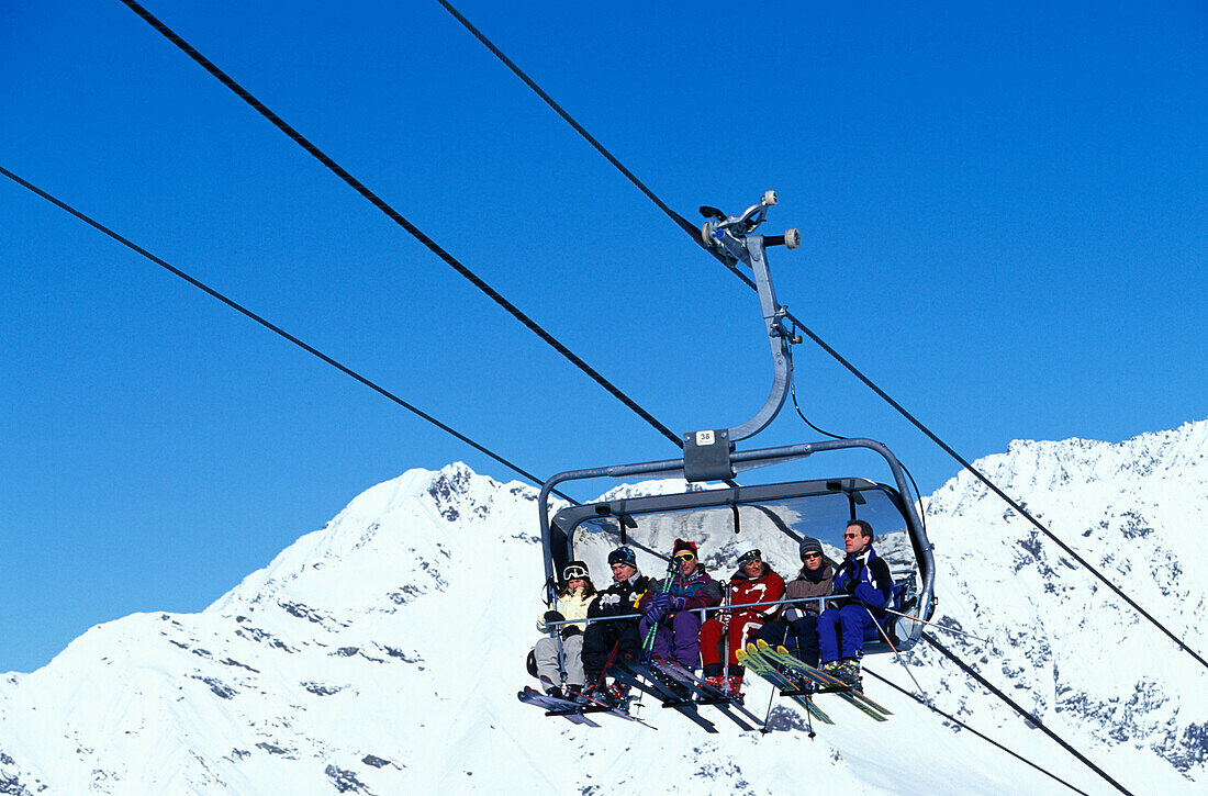 Six people sitting in a ski Lift, Skiing, Stubaital Glacier, Tirol, Austria