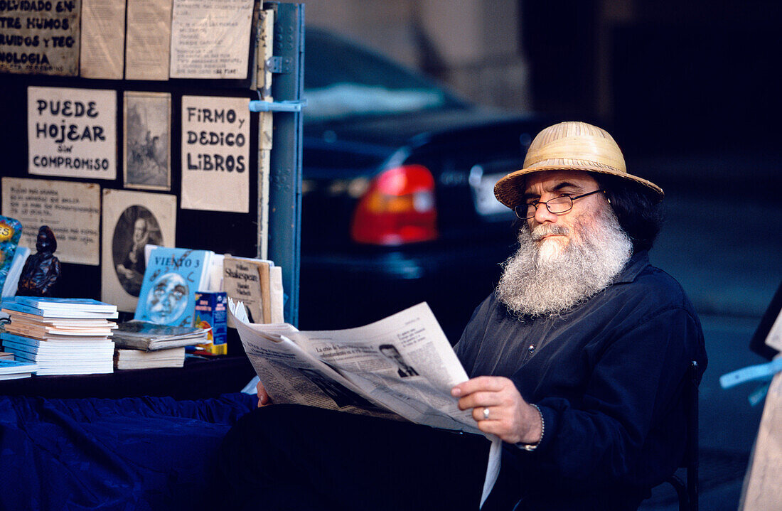 Man Beard Reading Barcelona, Bookseller with beard is waiting for clients in Las Ramblas, Els Quatre Gats Restaurant, Barcelona, Catalonia, Spain