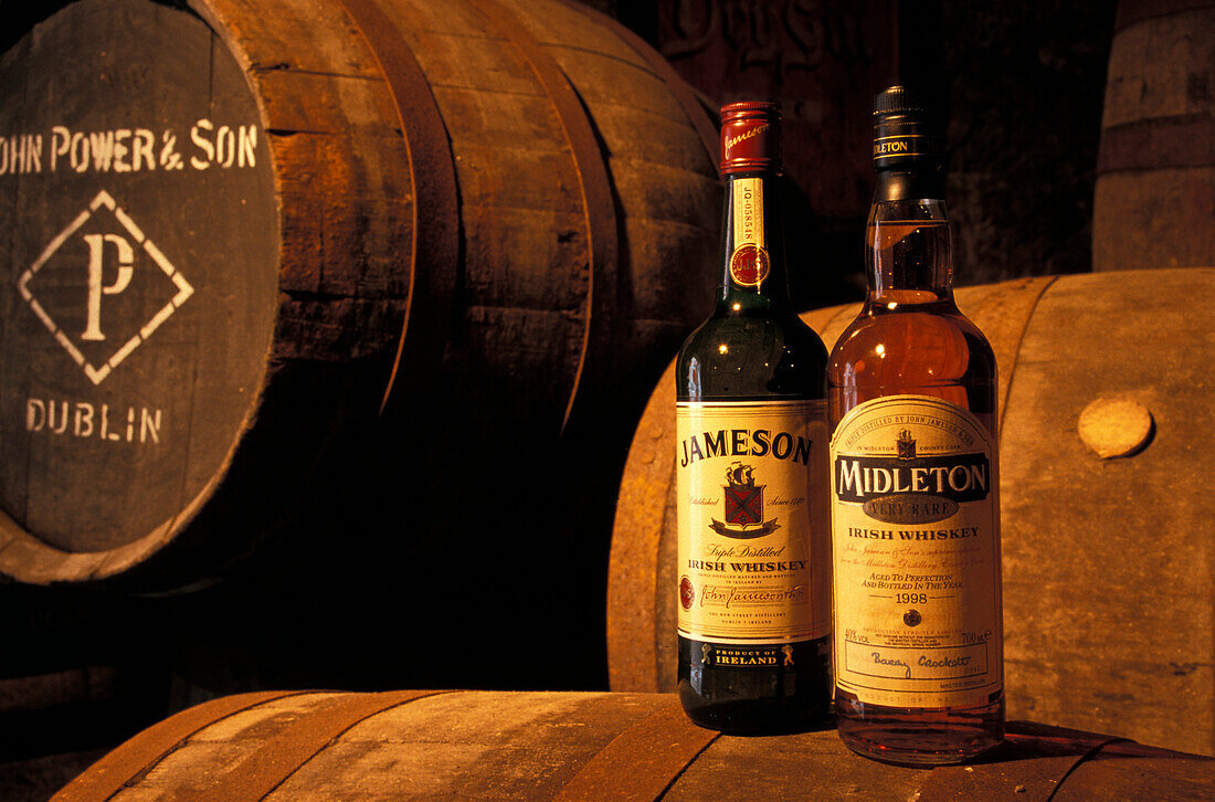 Zwei Flaschen Whiskey neben Fässer, Jameson Destillery, Midleton, Co. Cork, Irland
