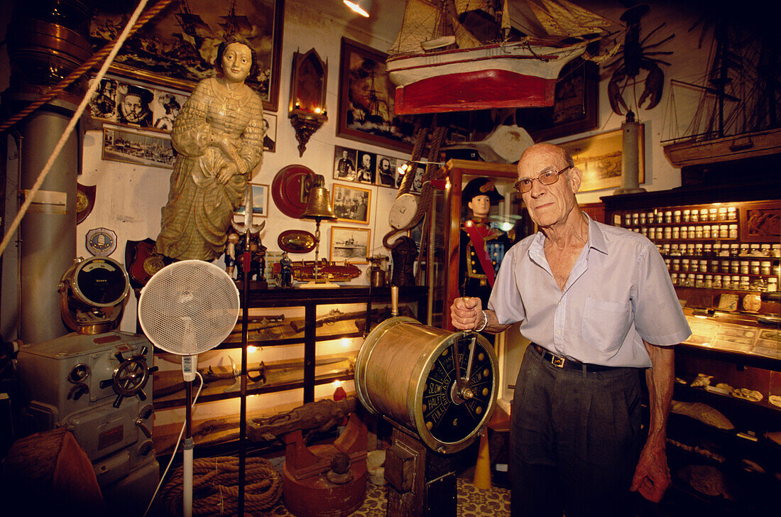 Older man in the museum, Museu de Curiositals Marineres, Sr. Roig Toques, Vilanova i la Celtru, Catalonia, Spain