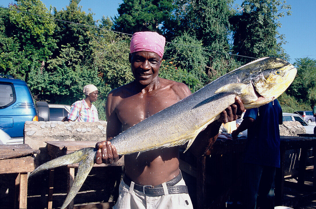 Fisherman presenting a fish, Boccoo Tobago