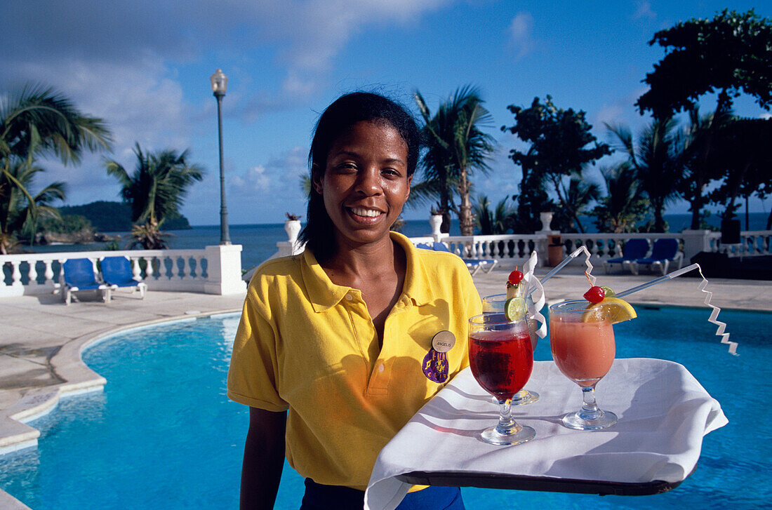 Waitress carrying cocktails at the pool of Hotel Gran Bahia, Samana, Samana Peninsula, Dominican Republic, Caribbean