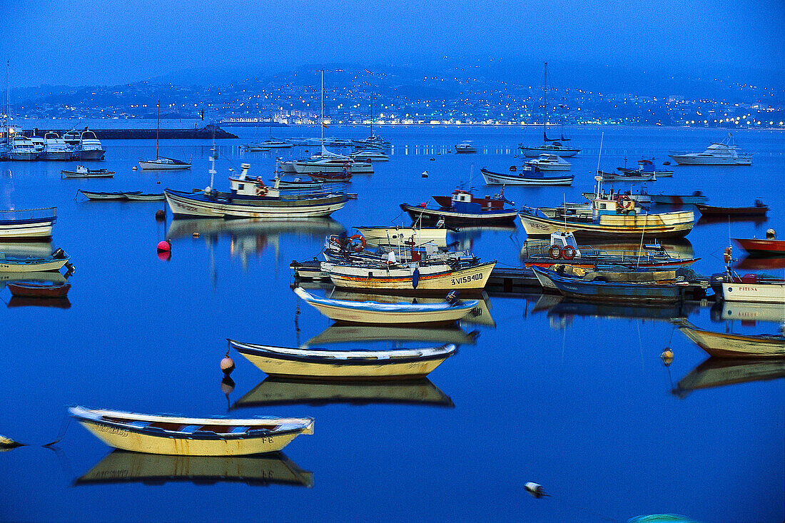 Fishing boats in the harbour at night, Ria de Baiona, Pontevedra, Galicia, Spain
