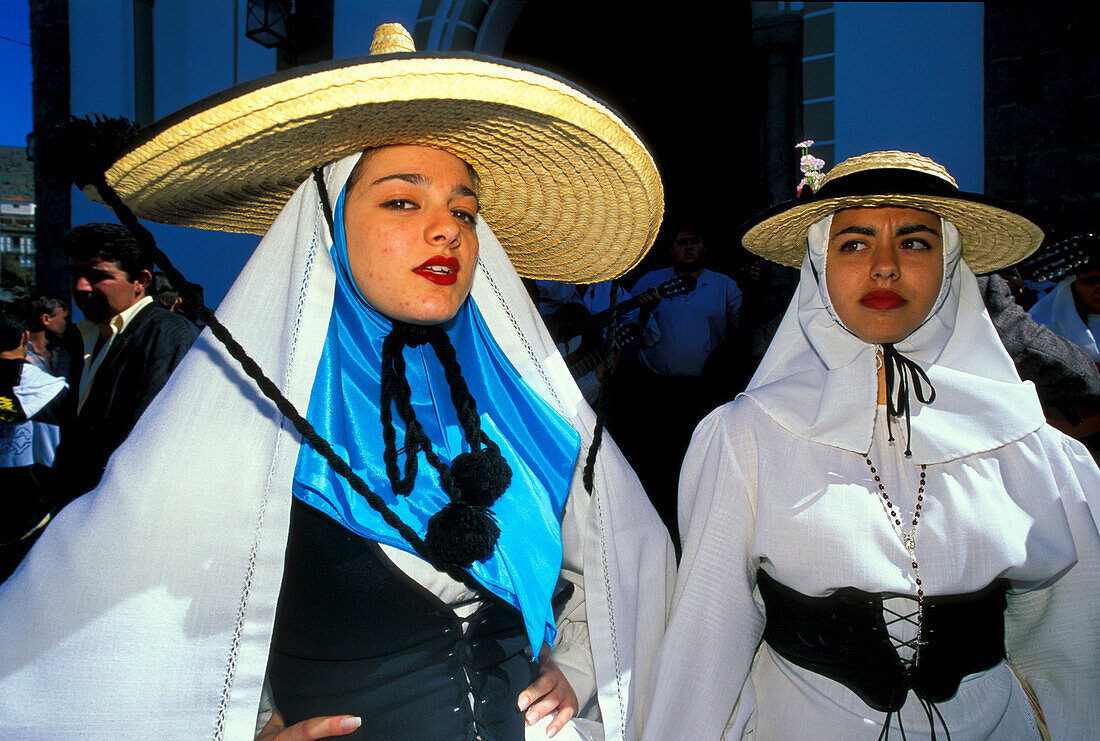 Two women in traditional clothes at the festival of the almond flower, Folklore music, Canary Islands, Spain