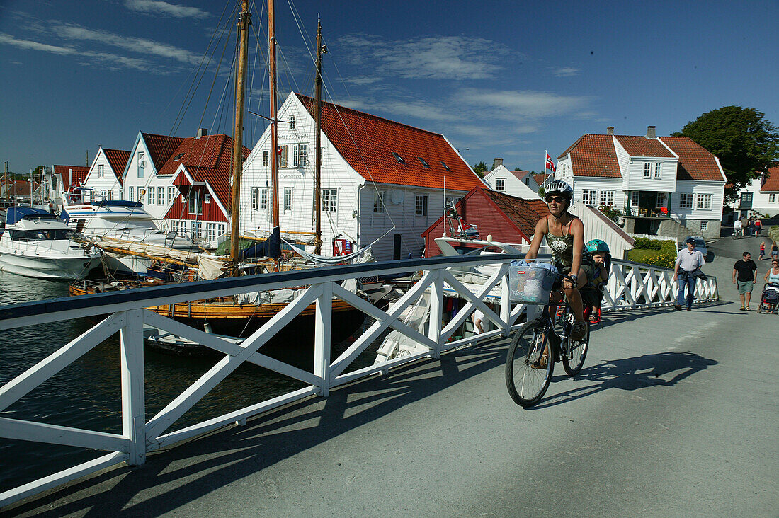 Mother and child on a bike, Torvet, Risor, Aust Augder, Norway