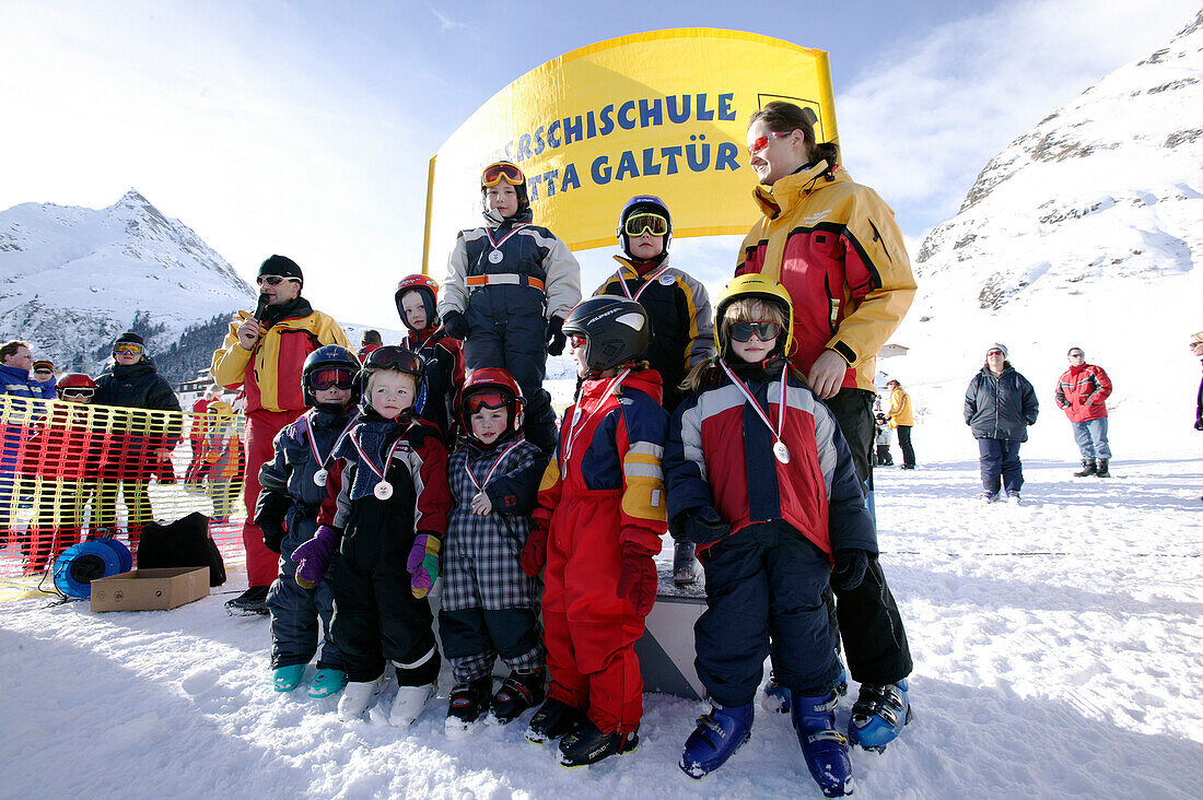 Ski Kids with Instructor, after race with medals, Wirl near Galtuer, Tirol, Austria