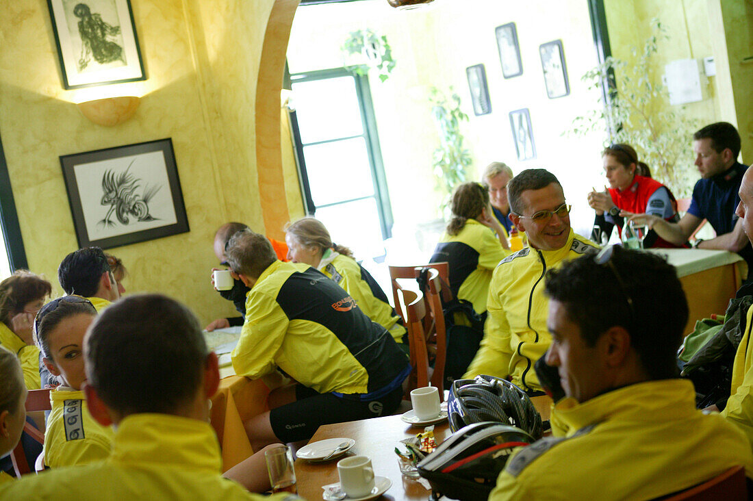 Group of cyclists in a restaurant, Porto Christo, Majorca, Balearic Islands, Spain