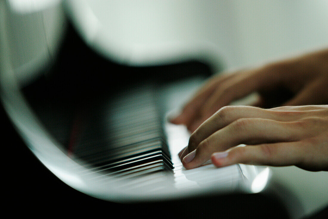 Man playing piano, close-up hands, Germany