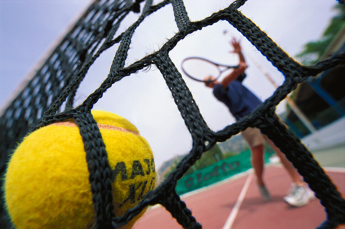 Tennisspieler spielt den Ball ins Netz, Fort Village, St. Margherita di Pula, Sardinien, Italien