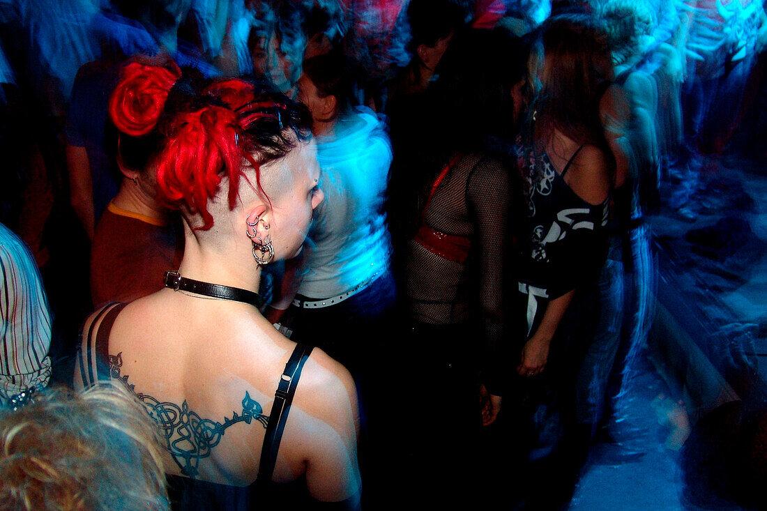 Young woman with tatoo, punk, in the disco, Nightlife, Berlin, Germany