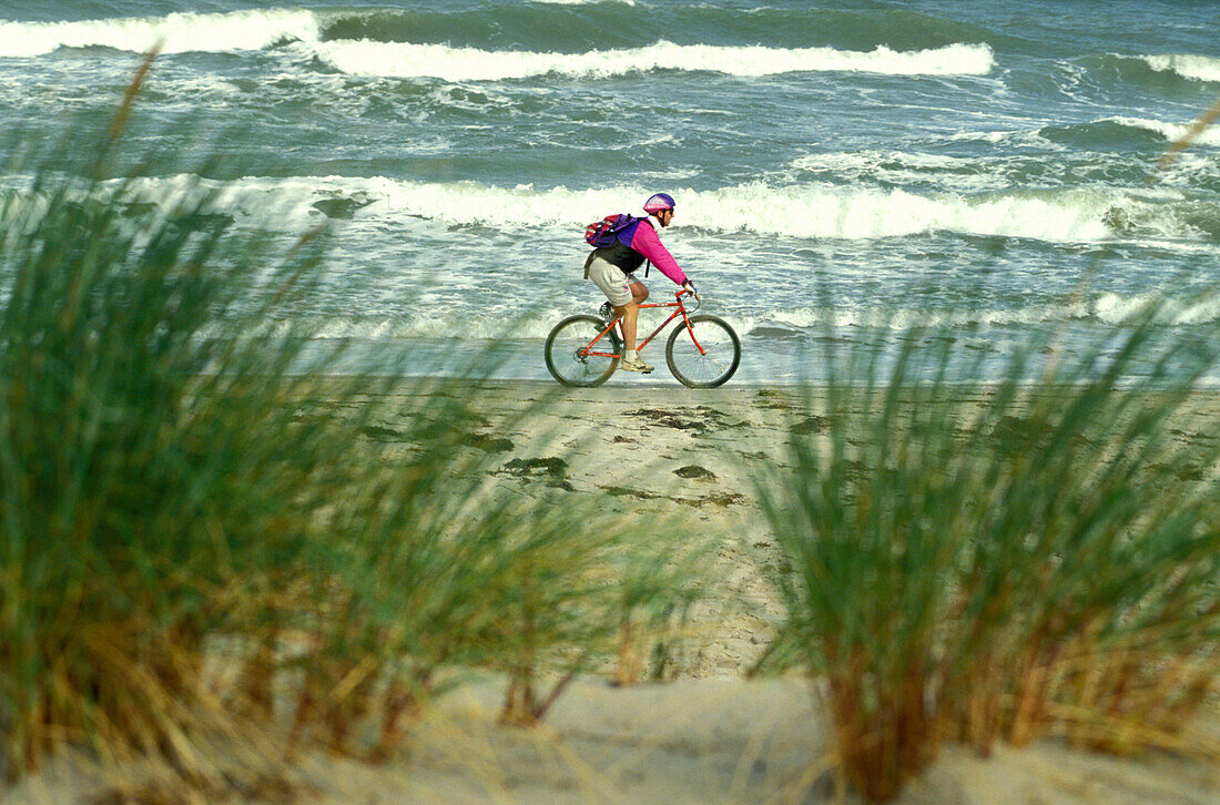 Cyclist on the beach, Baltic Sea, Mecklenburg-Western Pomerania, Germany