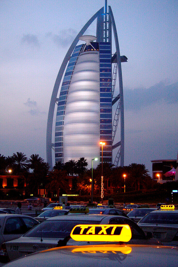 View at taxis and the hotel Burj al Arab in the evening, Dubai, United Arab Emirates, Middle East, Asia