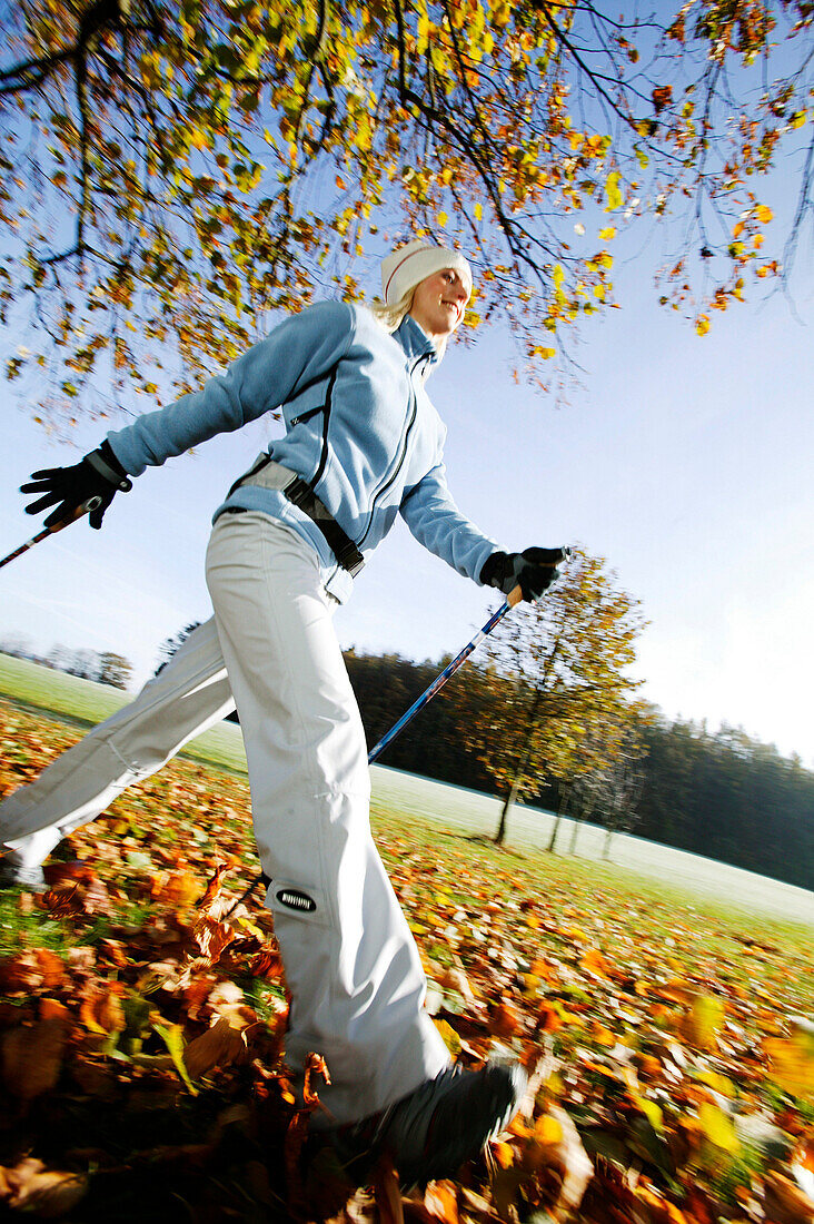 Young woman Nordic Walking, Bavaria, Germany