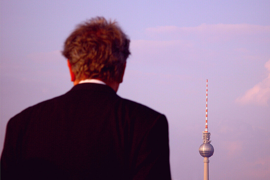 Man infront of television tower, berlin, germ