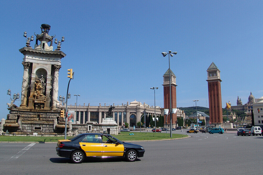 Torres Venicianes, venetian towers and cars at Plaza de Espanya, Barcelona, Spain, Europe