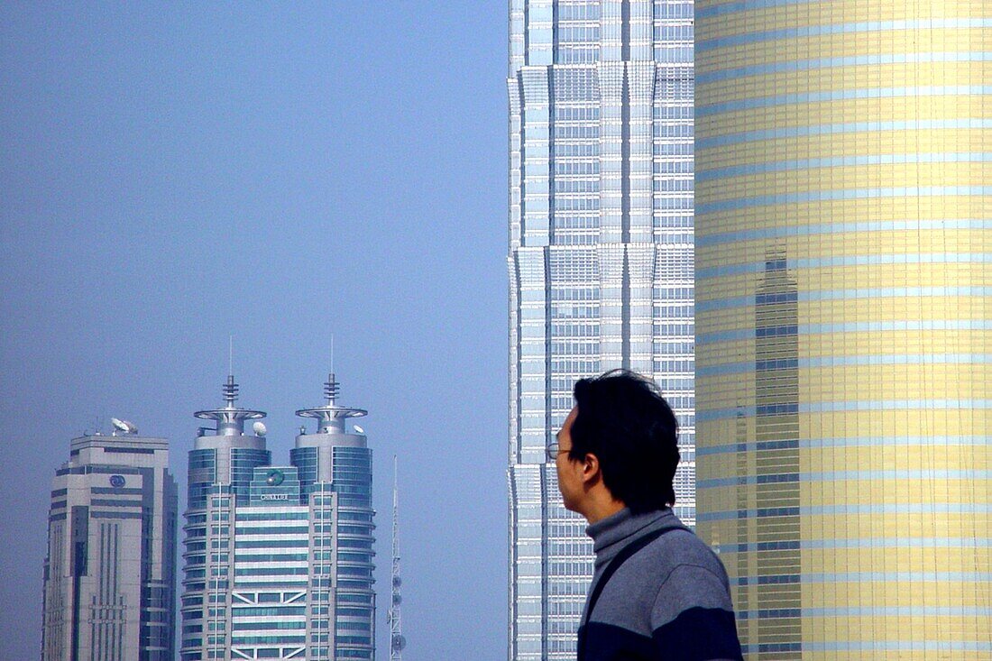 Chinese looking to high rise buildings at Pudong, Shanghai, China, Asia