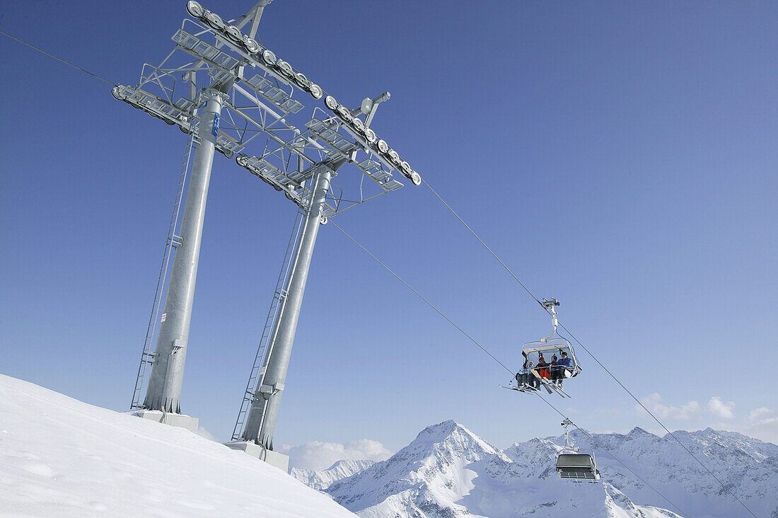 Skiers in chair lift, Kuhtai, Tyrol, Austria