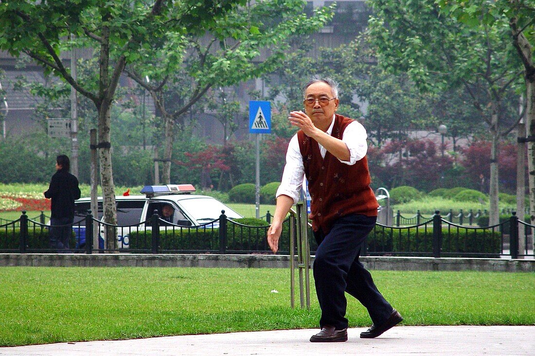 Alter Mann macht Gymnastik im Park, Shanghai, China, Asien