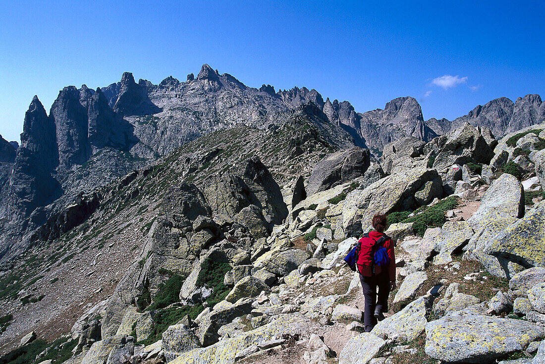 Woman hiking on route GR 20, Tightrope Walk, Resto a Valley, Corsica, France