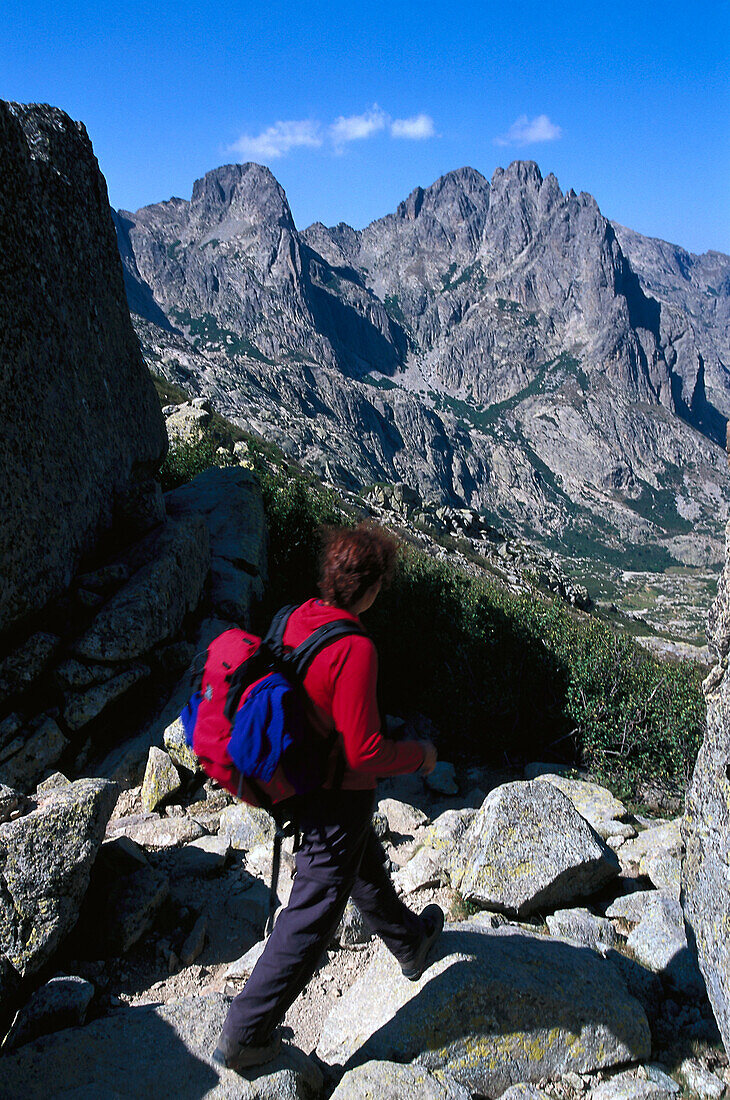 Woman hiking on route GR 20, Tightrope Walk, Resto a Valley, Corsica, France