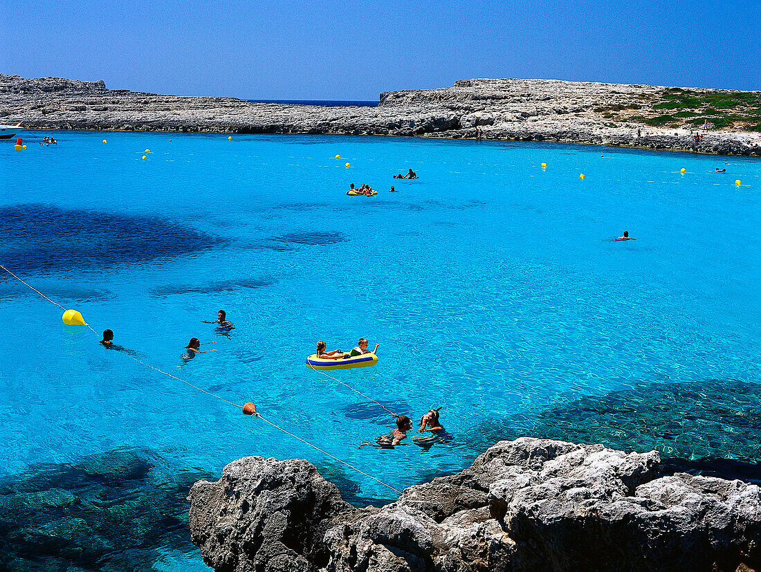 People swimming in the sea, Cala Binibeca, Minorca Spain