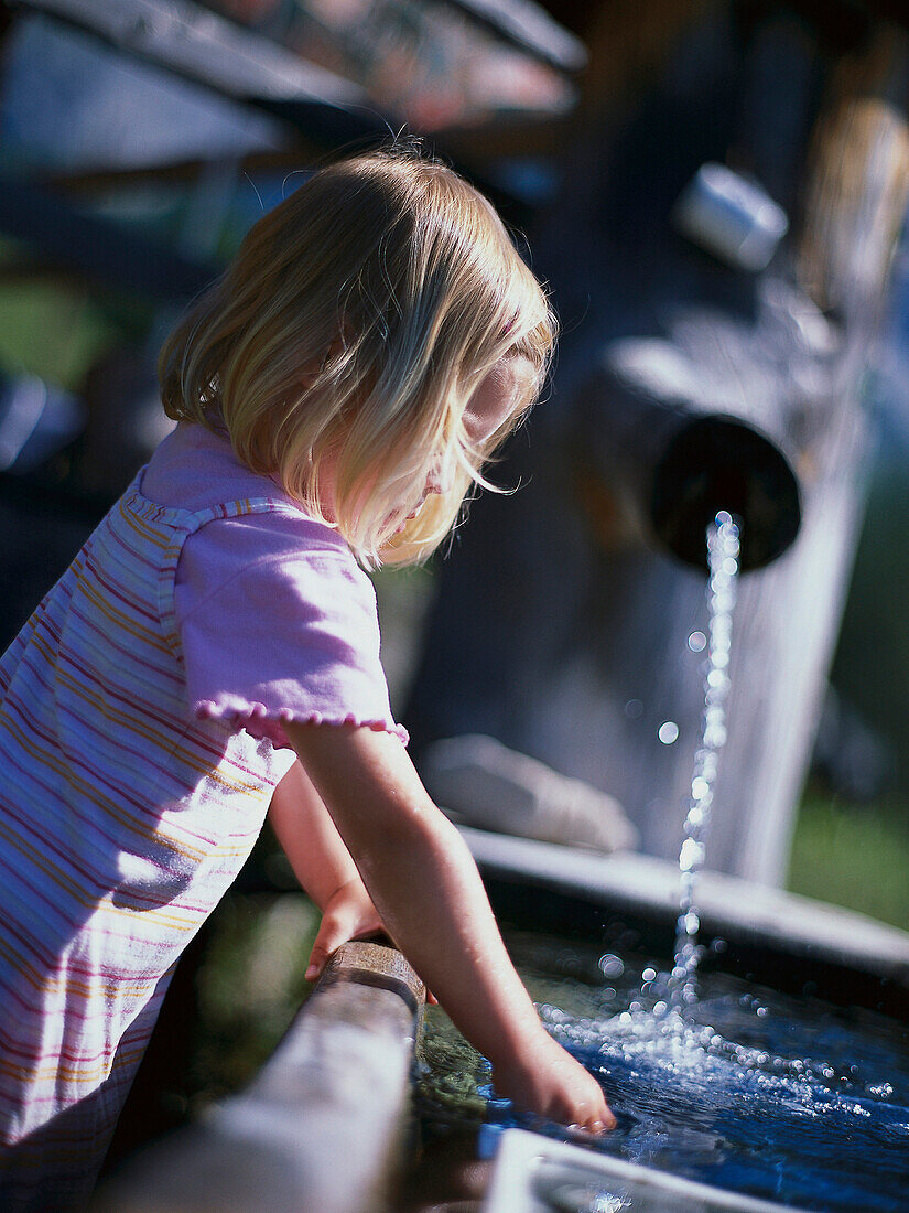 Little Girl on a fountain, Little Girl playing at a fountain, Ramsau am Bachstein, Styria, Austria