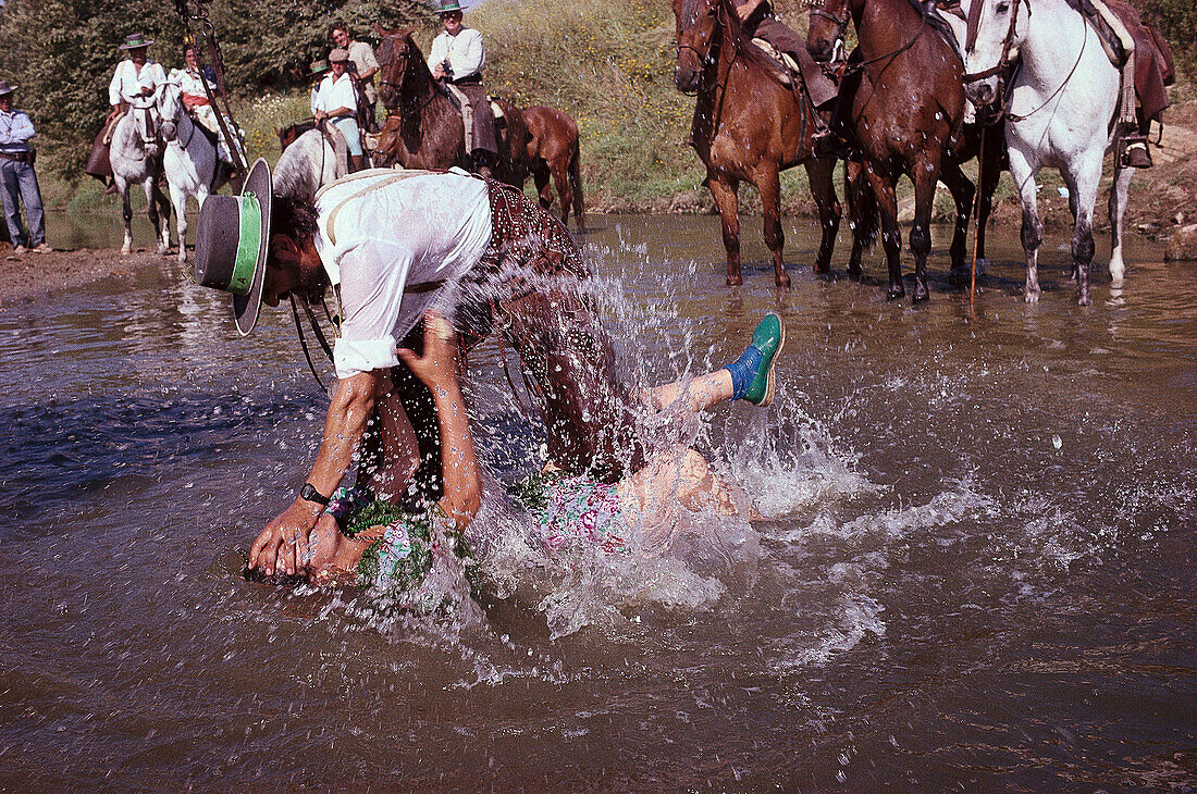 A pilgrim being baptized in the river Rio Quema, Andalusia, Spain