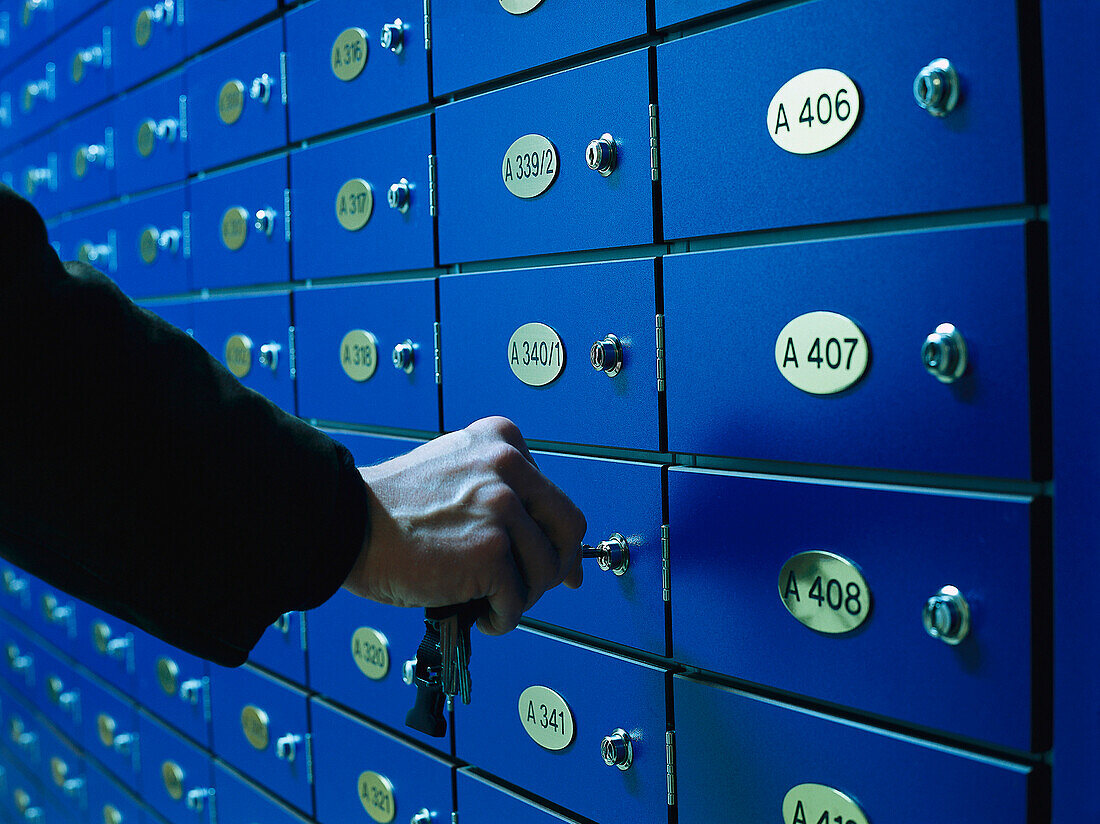 Man opening a safe deposit box in a Bank, Business