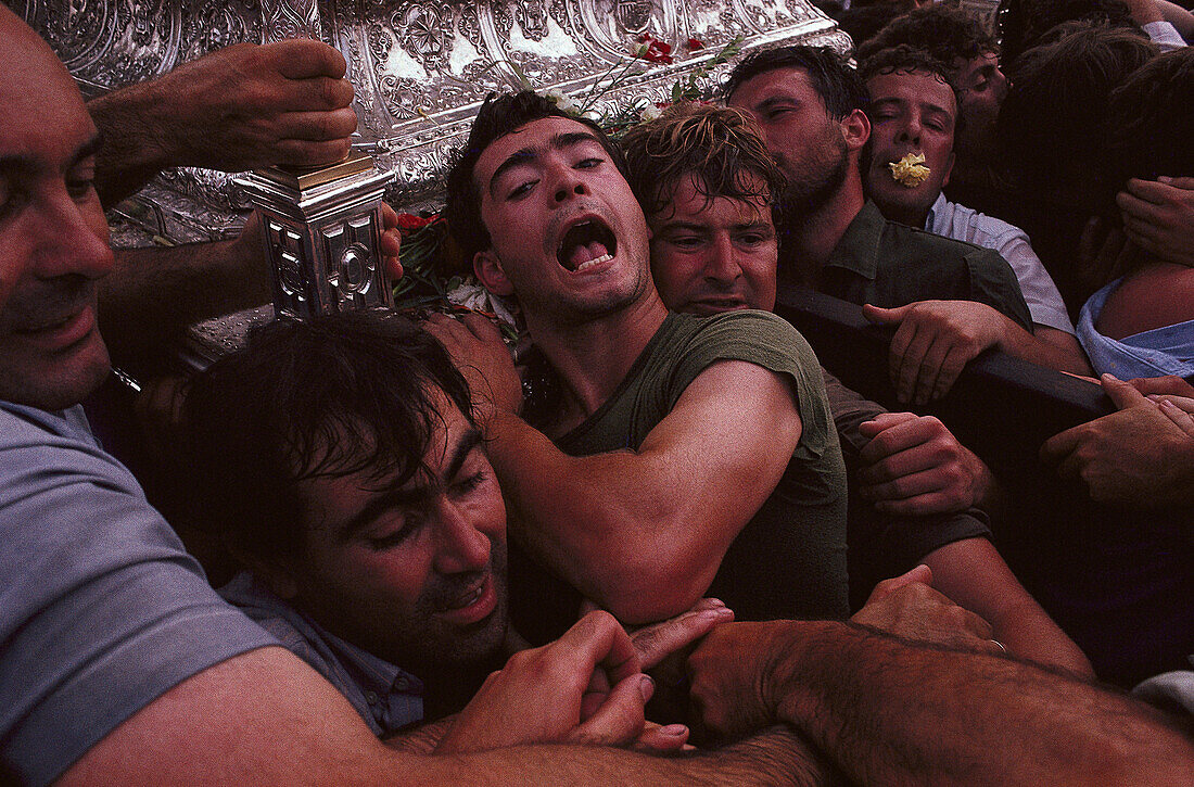Pilgrims under the heavy burden of the Madonna of El Rocío, Andalusia, Spain