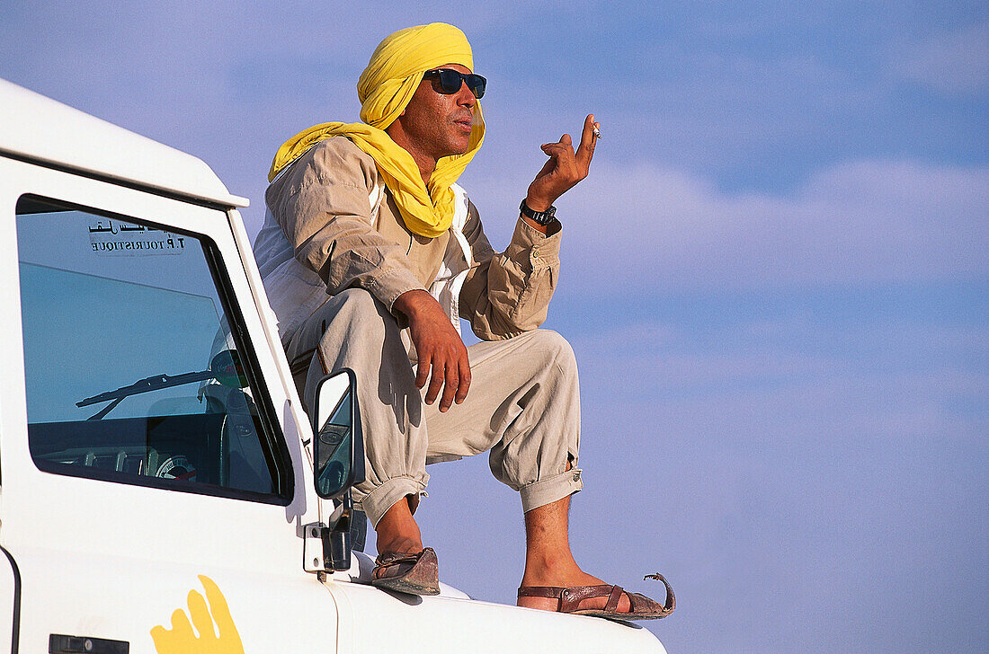 Chauffeur sitting on a jeep, Jeep Tour, Salt Desert, Chott el Djerid, Tunesia