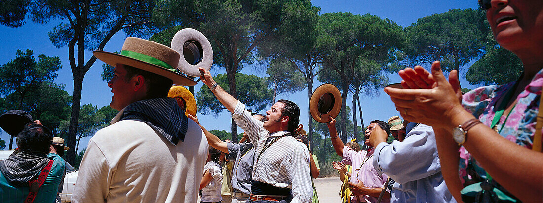 Pilgrims clapping hands and saluting on the Raya Real, Andalusia, Spain