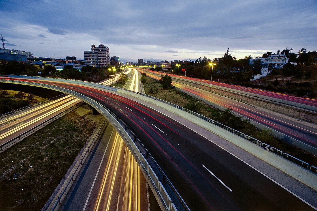 Luminous tracks, blurred motion of automobile headlights, city highway M-30, Madrid, Spain
