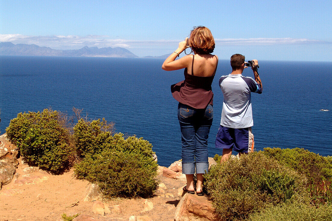 Tourists on a rock at Cape Peninsula, Cape Town, South Africa, Africa