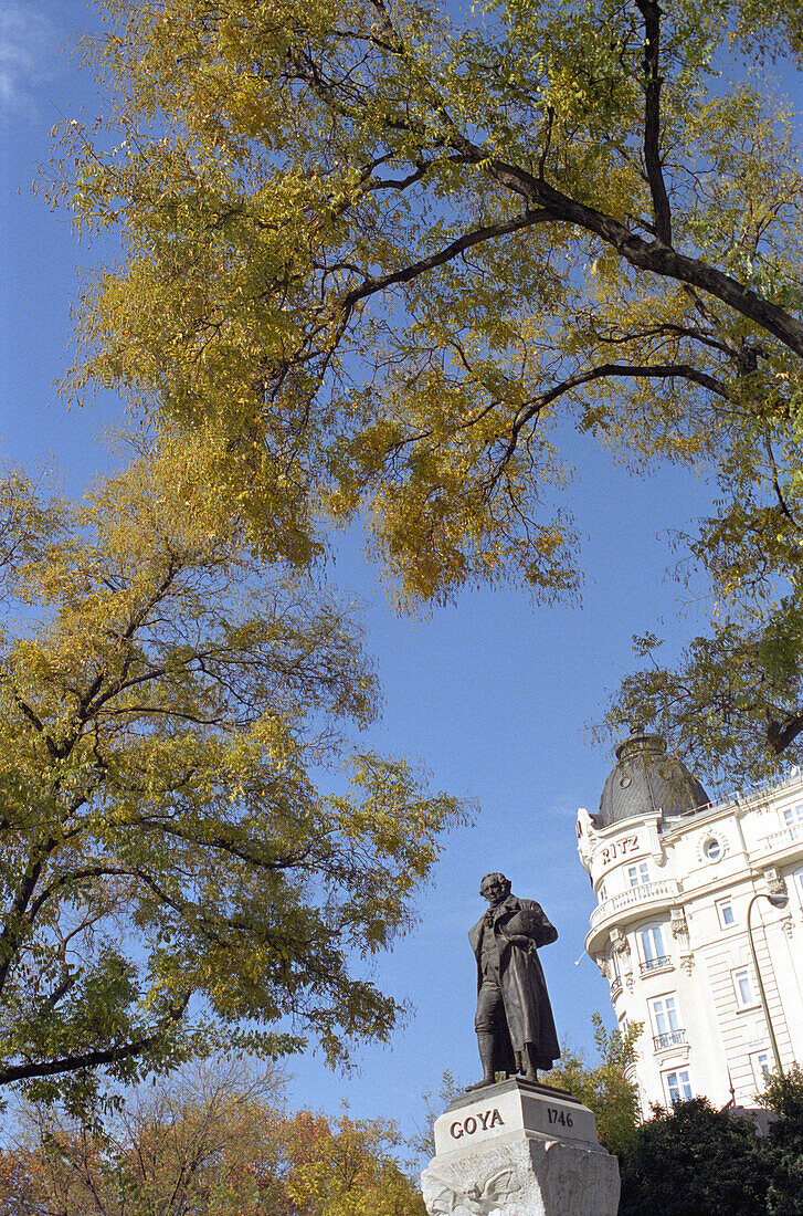 Goya sculpture beneath trees in the sunlight, Madrid, Spain, Europe