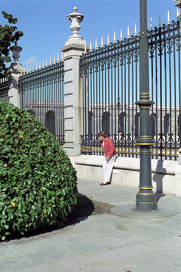 Mensch vor Zaun des Palacio Real, Madrid, Spanien