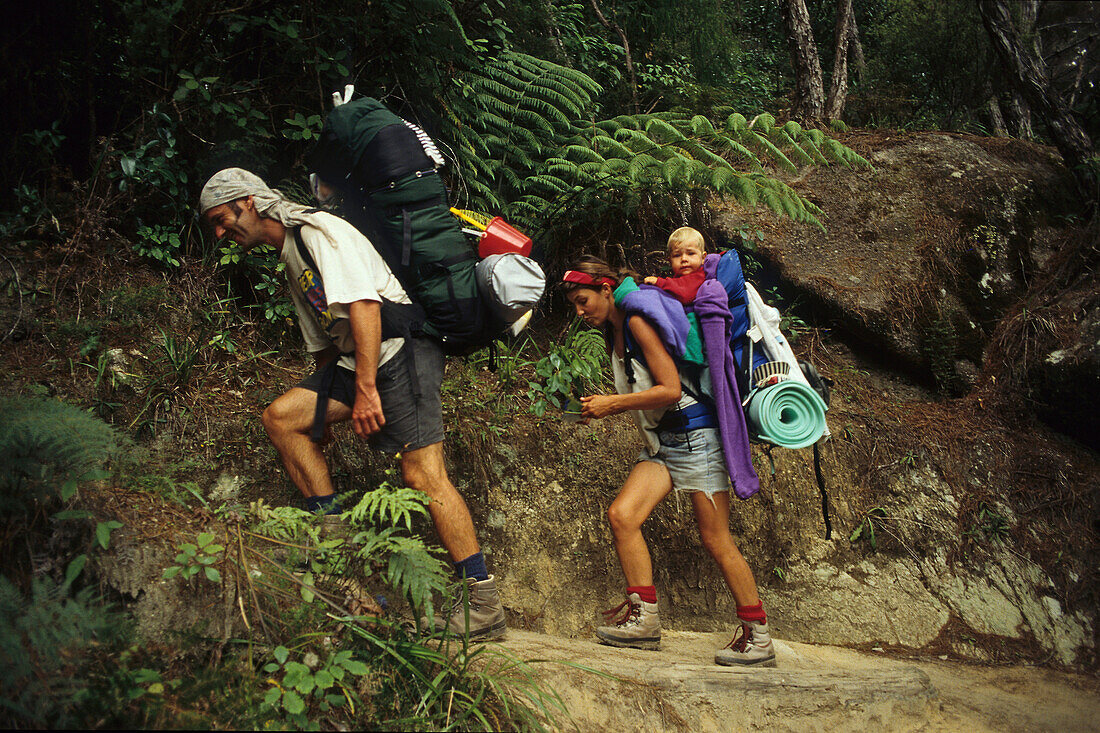 Hikers with child on Abel Tasman Coast Track, Abel Tasman National Park, New Zealand, Oceania