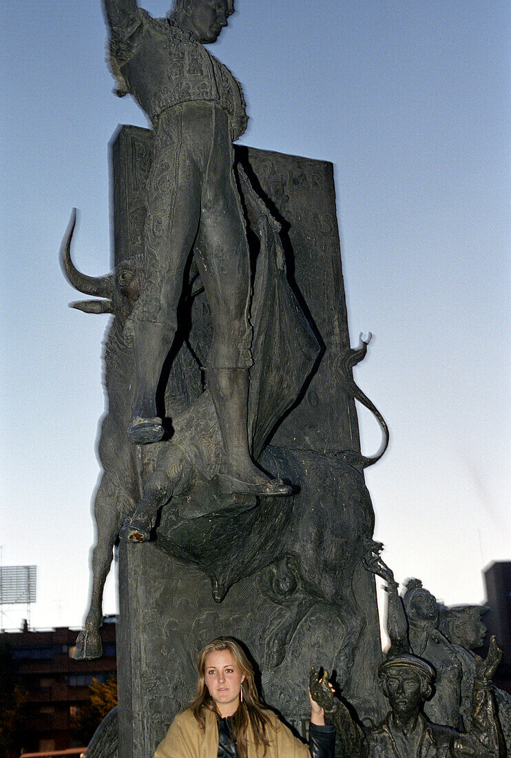 Woman in front of a statue at sunrise, Madrid, Spain, Europe