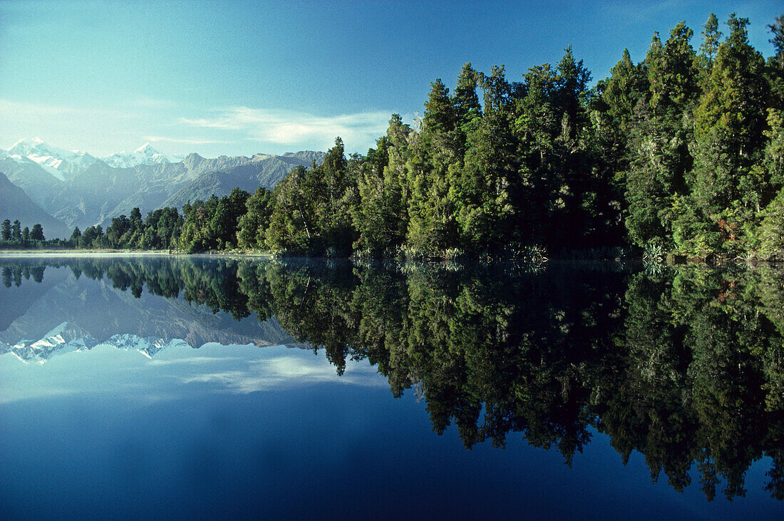 Reflections of Southern Alps and Mount Tasman and Cook on Lake Matheson, South Island, New Zealand, Oceania