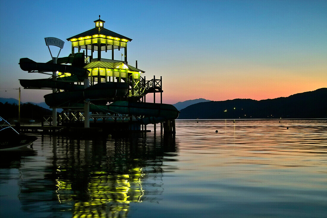 Illuminated lido at lake Woerth, Poertschach, Carinthia, Austria