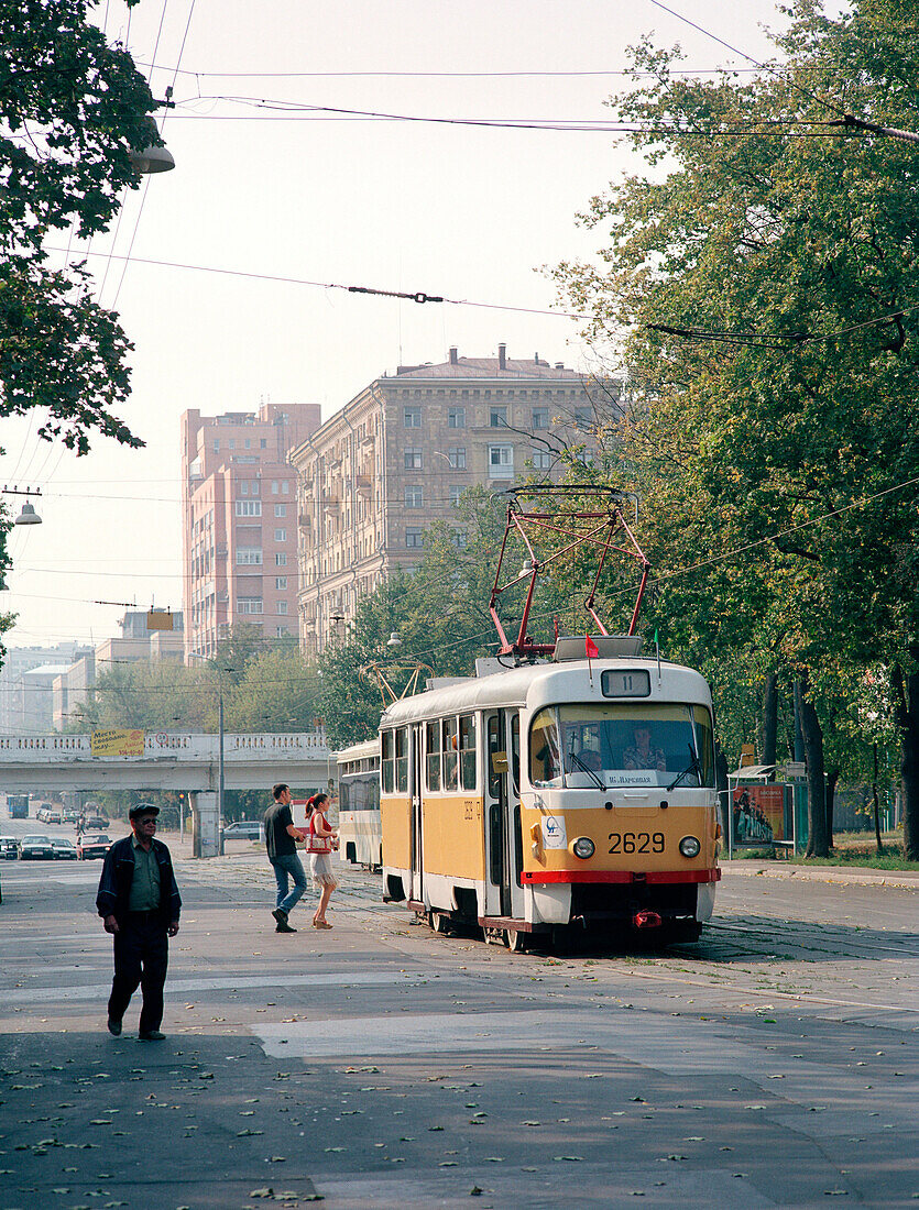 Street setting, people walking towards a tram, Moscow Russia