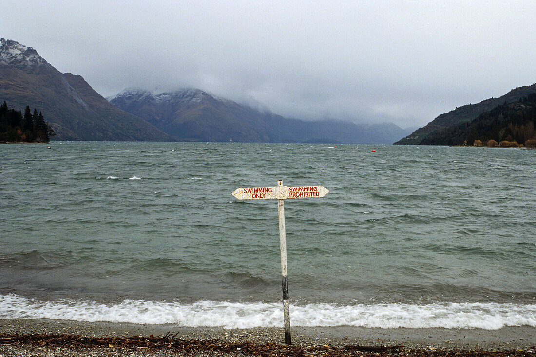 Sign on lakeside, Queenstown, swimming only, swimming prohibited, sign on waterfront, bad weather
