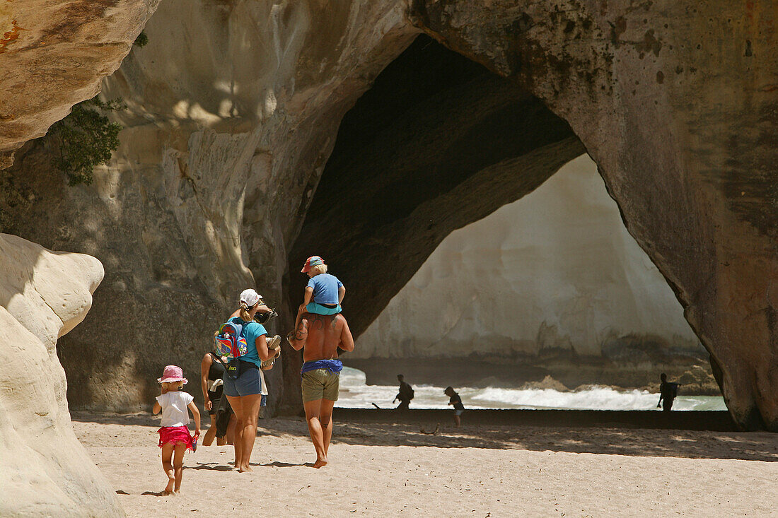 People on the beach in front of Cathedral Cave at Coromandel Peninsula, North Island, New Zealand, Oceania